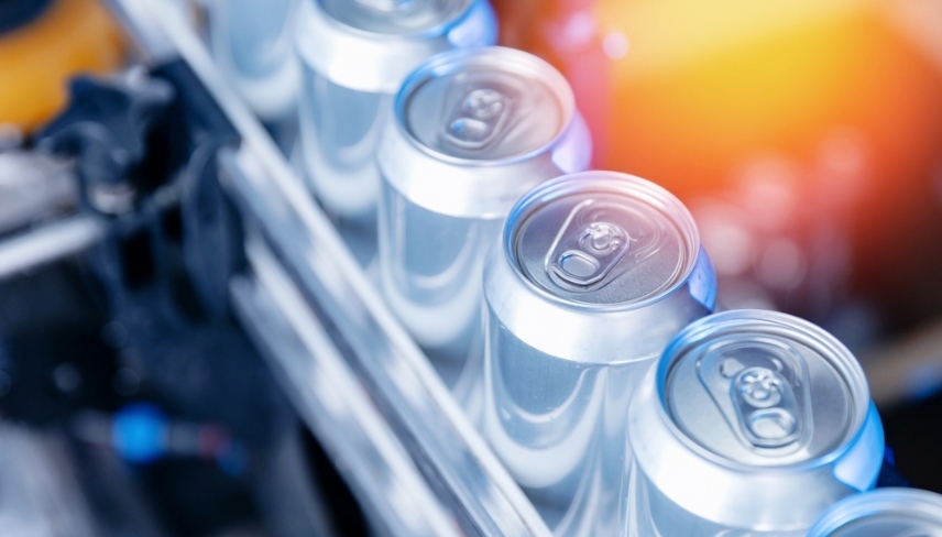 Top view Modern beer canning line in brewery with shiny aluminum cans and equipment.