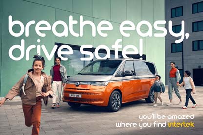 Family walking near a modern orange and black van with the text "breathe easy, drive safe!" and Intertek logo.