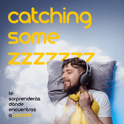 Man laying in bed listening to headphones