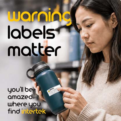 A woman reading a label on a water bottle in a store